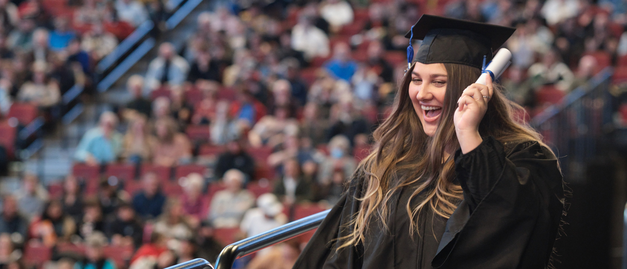 ܽƵapp graduate raises diploma at December 2023 ceremony. 